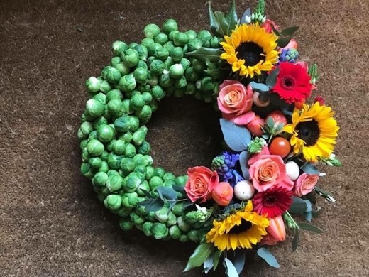 specialist wreath made of sprouts and seasonal flowers