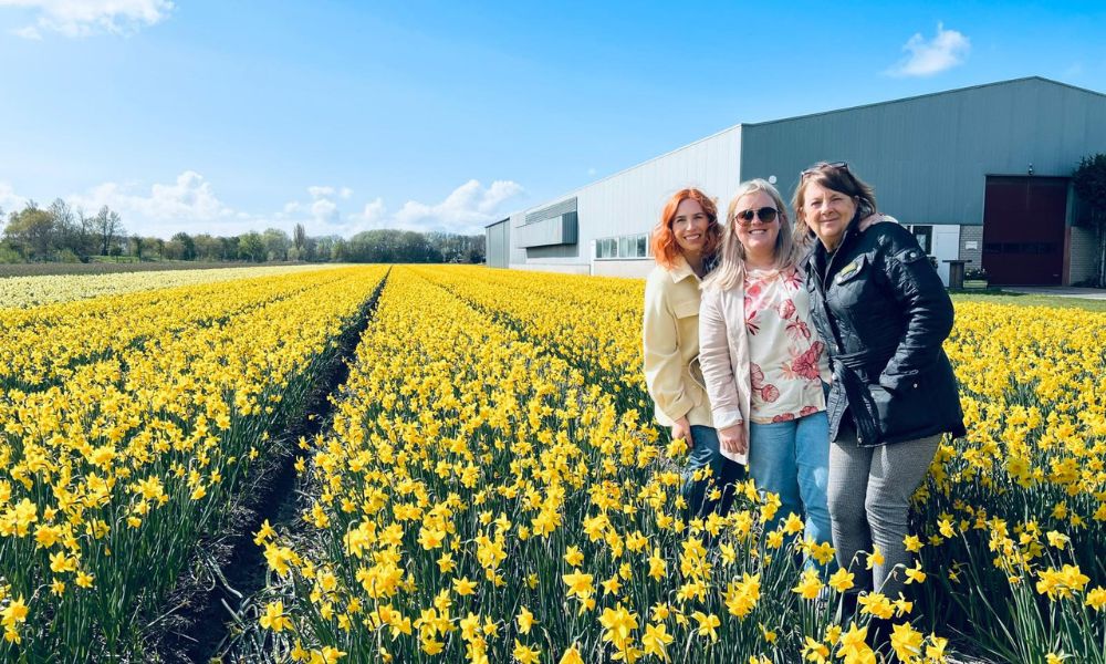 Rachel and The Dancing Daffodil team standing in the flower fields in Holland