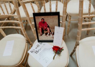 Photo of Darren, Ryan's Dad, placed on the chair where he should be sat accompanied with his buttonhole