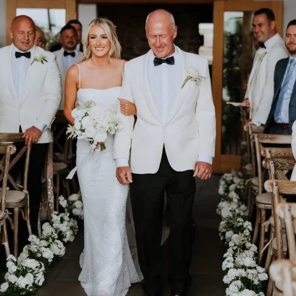 A bride walking down the aisle with her dad giving her away