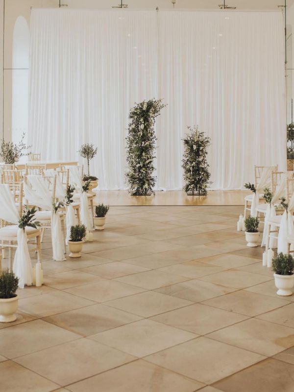Micro Weddings For Meaningful Moments - Wedding ceremony laid out with white theme and green leaves