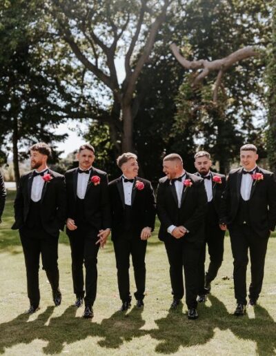 The Dancing Daffodil - Ashton & Josh - Groom and groomsmen wearing black suits and buttonholes