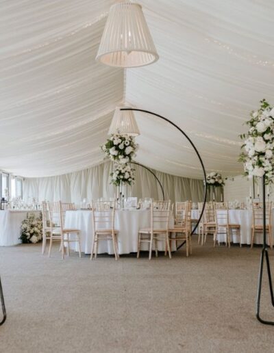 The Dancing Daffodil - Ffion & Logan - Hanging flower clouds with Welcome plaque and table seating arrangements